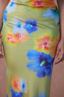a woman wearing a dress with flowers on it