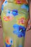 a woman wearing a dress with flowers on it