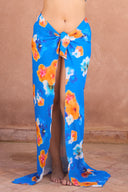 a woman wearing a blue and orange floral skirt