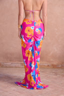 a woman wearing a floral skirt