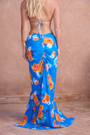 a woman wearing a blue floral dress