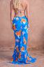 a woman wearing a blue floral dress