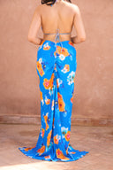 a woman wearing a blue floral dress