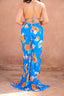 a woman wearing a blue floral dress
