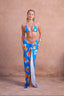 a woman in a blue garment and pants