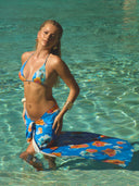 a woman in a garment and a swimsuit in a pool